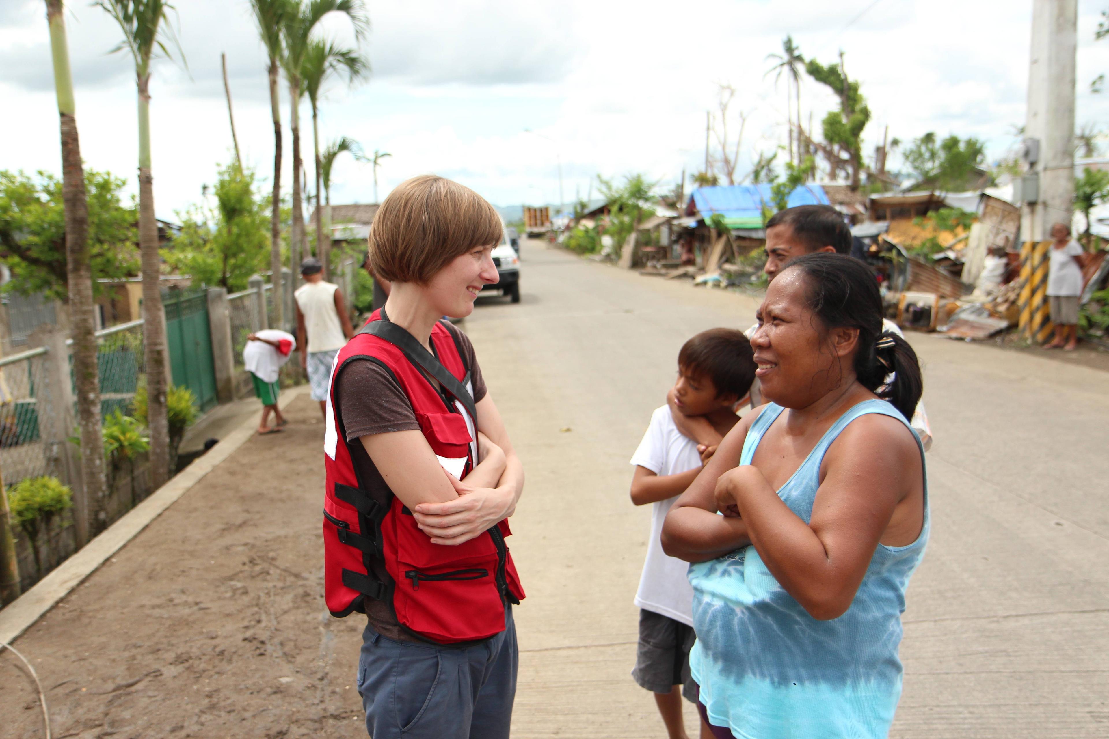 Nicole in discussion with a Philippines local after Typhoon Haiyan